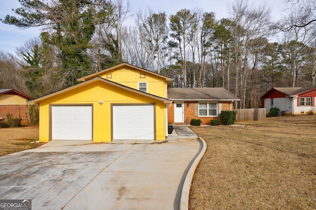 view of front of home featuring a garage and a front yard