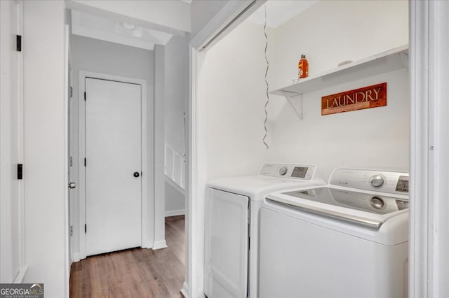 laundry area featuring light hardwood / wood-style floors and washing machine and clothes dryer