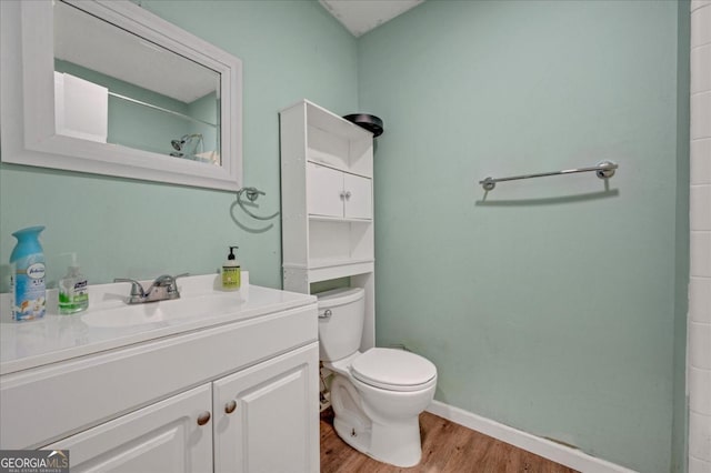 bathroom featuring vanity, wood-type flooring, and toilet