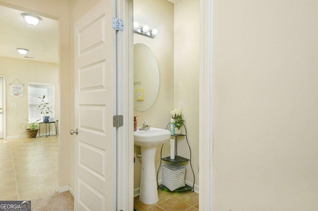 bathroom with tile patterned flooring and sink