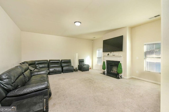 living room with plenty of natural light and carpet flooring