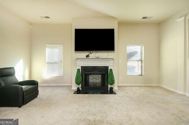 living room with light colored carpet and a healthy amount of sunlight