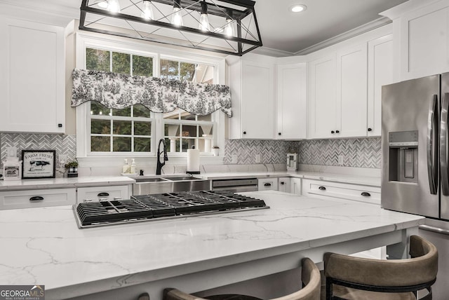 kitchen featuring white cabinetry, a breakfast bar area, and appliances with stainless steel finishes