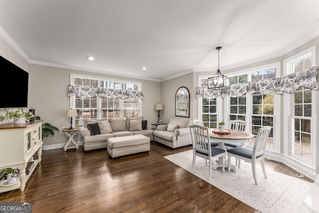 living room with crown molding, a notable chandelier, dark hardwood / wood-style floors, and a wealth of natural light