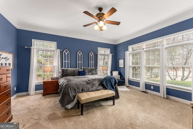 carpeted bedroom featuring ceiling fan, ornamental molding, and multiple windows