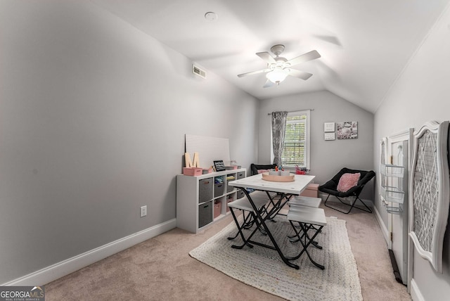 carpeted office space with ceiling fan and vaulted ceiling