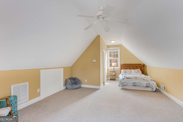 unfurnished bedroom with ceiling fan, lofted ceiling, and carpet