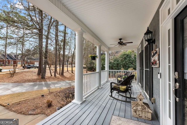 wooden deck with ceiling fan and covered porch