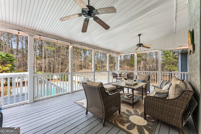 sunroom / solarium with ceiling fan and vaulted ceiling