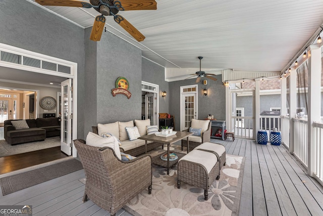 wooden deck featuring an outdoor living space and ceiling fan