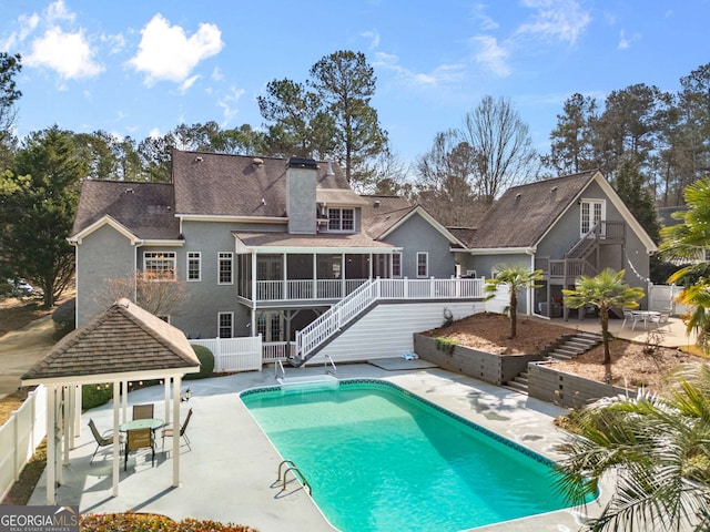 back of property with a gazebo, a sunroom, and a patio