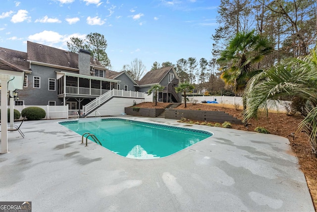 view of pool featuring a patio and a sunroom