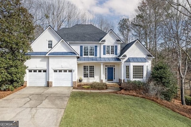 traditional home with concrete driveway, metal roof, roof with shingles, a standing seam roof, and a front lawn