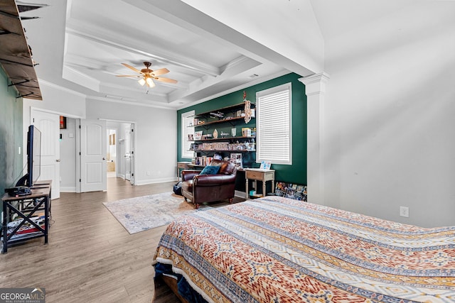 bedroom featuring decorative columns, coffered ceiling, wood-type flooring, ornamental molding, and beamed ceiling