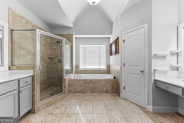 bathroom featuring vanity, lofted ceiling, shower with separate bathtub, and tile patterned floors