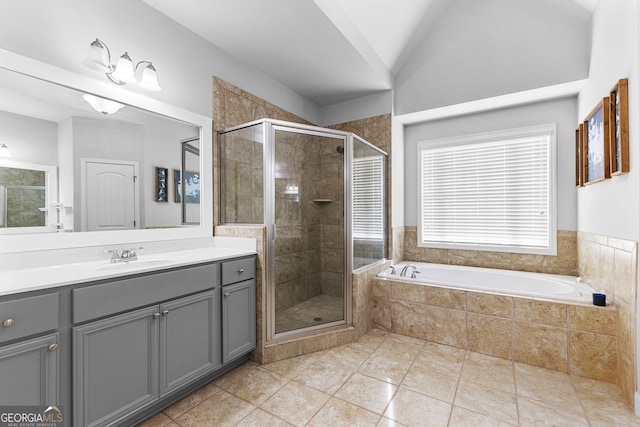 bathroom featuring shower with separate bathtub, lofted ceiling, vanity, and tile patterned floors