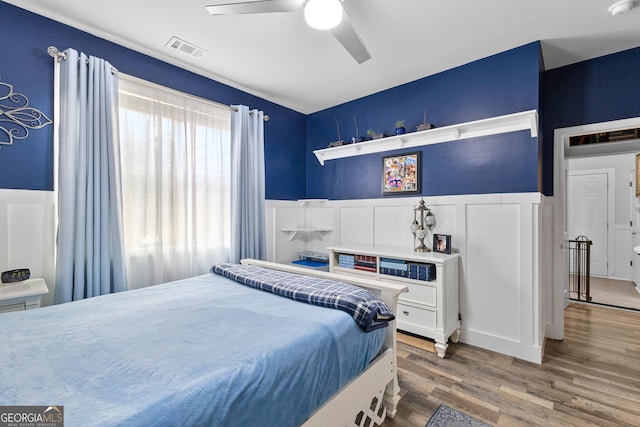 bedroom with hardwood / wood-style floors and ceiling fan