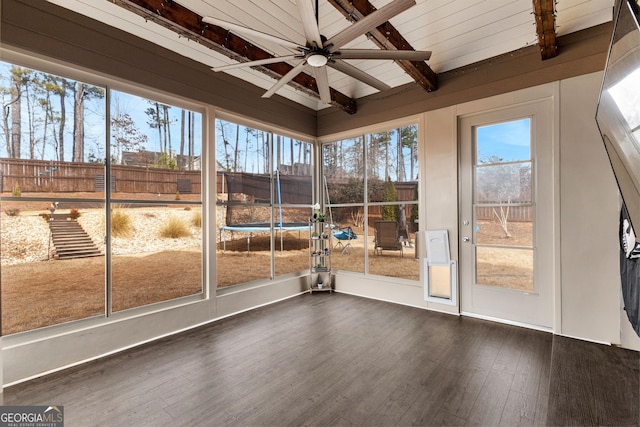 unfurnished sunroom featuring ceiling fan and lofted ceiling with beams