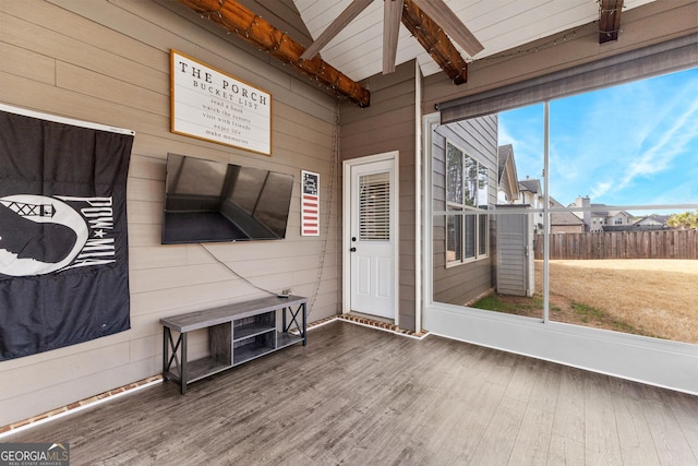 sunroom featuring beamed ceiling