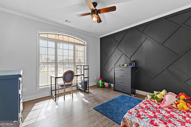 bedroom featuring crown molding, ceiling fan, and hardwood / wood-style flooring