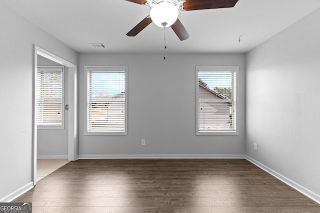 empty room featuring dark hardwood / wood-style floors and ceiling fan