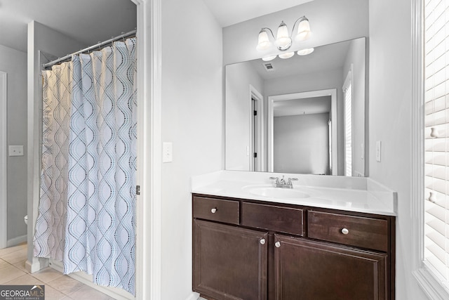 bathroom featuring tile patterned flooring, vanity, and a shower with curtain