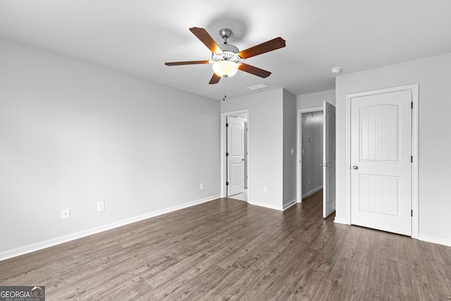 unfurnished bedroom with dark hardwood / wood-style flooring and ceiling fan