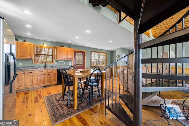 dining room featuring sink and light wood-type flooring