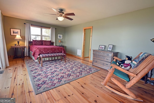 bedroom featuring hardwood / wood-style floors and ceiling fan