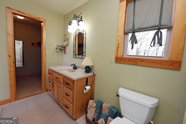 bathroom with vanity, tile patterned flooring, and toilet