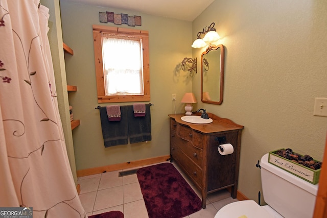 bathroom featuring vanity, tile patterned floors, and toilet