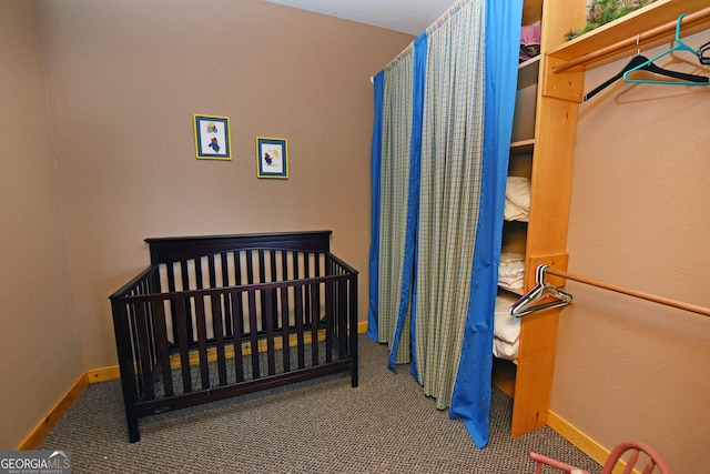 bedroom featuring a crib and carpet