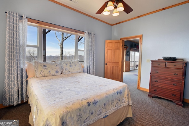 bedroom with crown molding, ceiling fan, and dark colored carpet