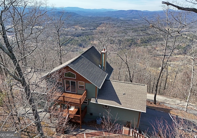 view of property exterior with a mountain view