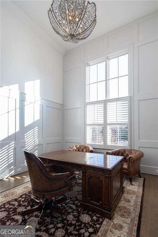 5152 Boulder Bluff Way, Suwanee, GA 30024 - office with a decorative wall, vaulted ceiling, a chandelier, plenty of natural light, and wood finished floors