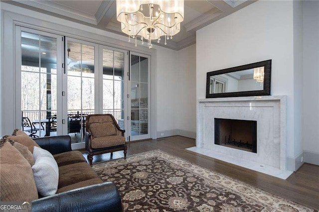 living room featuring an inviting chandelier, beam ceiling, coffered ceiling, a high end fireplace, and dark hardwood / wood-style flooring