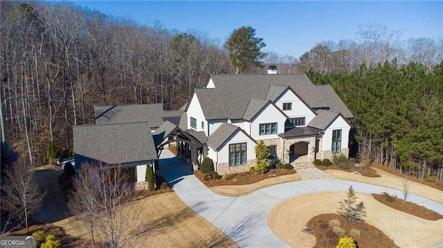5152 Boulder Bluff Way, Suwanee, GA 30024 - view of front facade with curved driveway, stone siding, stucco siding, and a chimney
