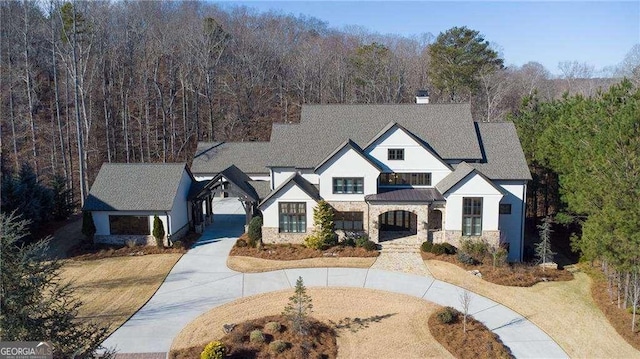 5152 Boulder Bluff Way, Suwanee, GA 30024 - view of front facade with a view of trees, stone siding, and stucco siding
