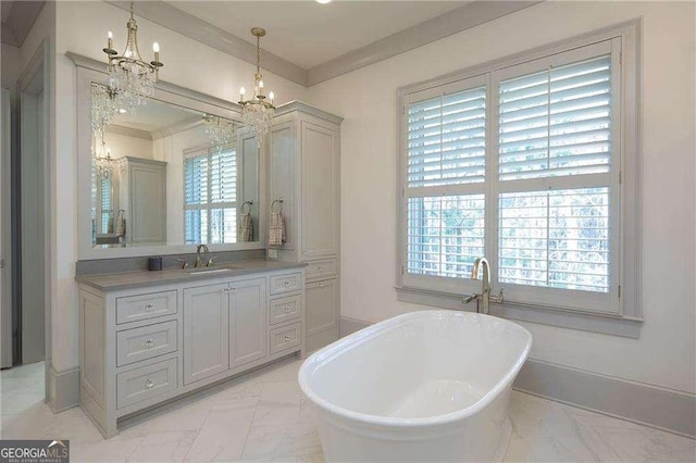 bathroom featuring crown molding, a washtub, vanity, and an inviting chandelier