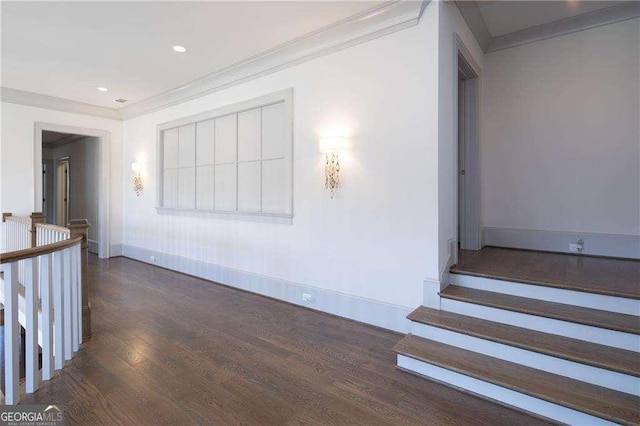 hall featuring ornamental molding and dark hardwood / wood-style floors