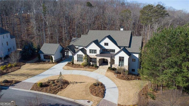 5152 Boulder Bluff Way, Suwanee, GA 30024 - view of front facade with a standing seam roof, a chimney, a metal roof, and curved driveway
