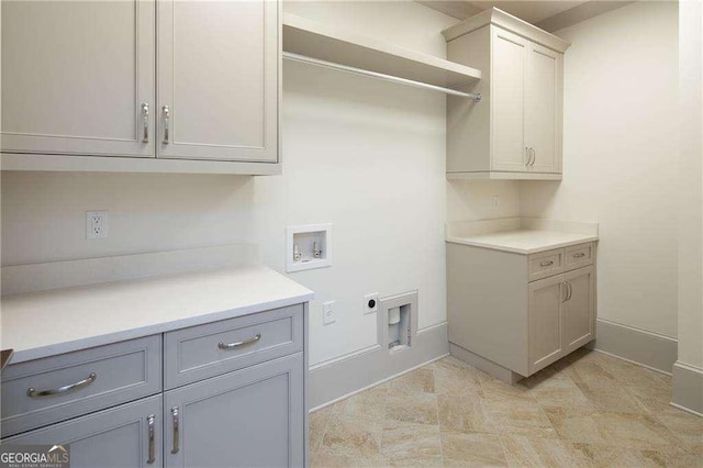 washroom featuring cabinets, washer hookup, and electric dryer hookup