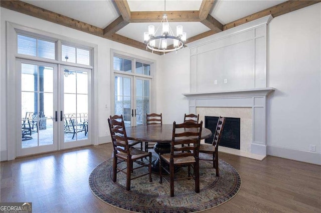 dining space with coffered ceiling, dark wood-type flooring, beam ceiling, and french doors