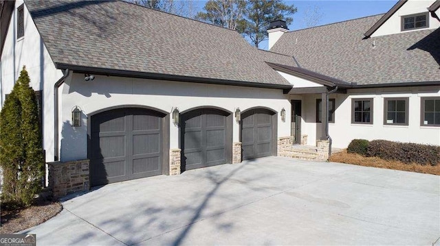 5152 Boulder Bluff Way, Suwanee, GA 30024 - view of front of home featuring a garage, driveway, a shingled roof, stucco siding, and a chimney