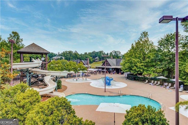 view of pool featuring a gazebo, a patio area, and a water slide