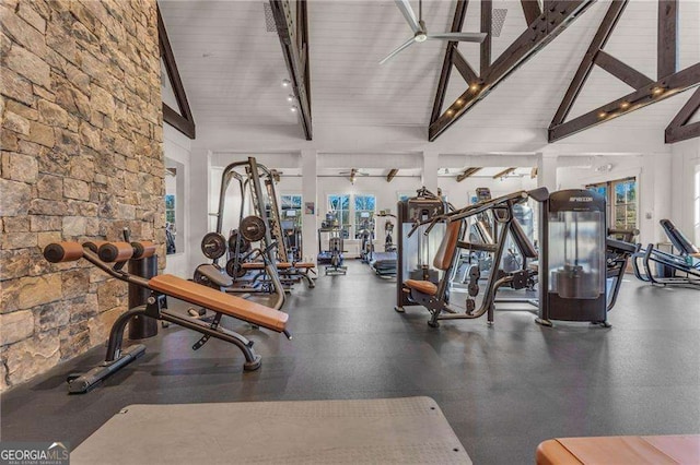 workout area with ceiling fan and high vaulted ceiling