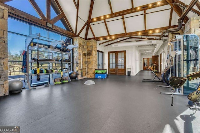 gym with high vaulted ceiling and french doors