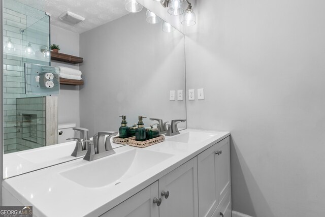 bathroom featuring a shower with door, a textured ceiling, and toilet