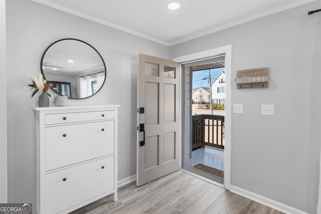 foyer entrance with baseboards, recessed lighting, light wood-style flooring, and crown molding