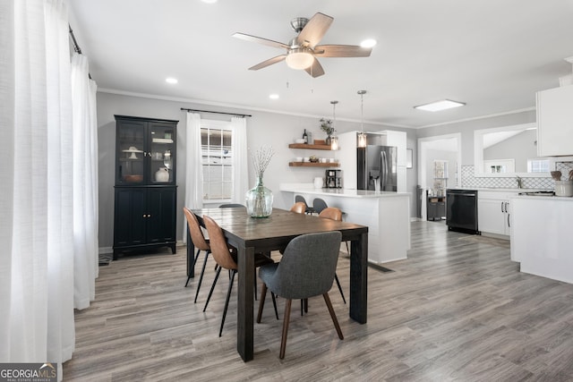 dining room with ornamental molding, light wood-type flooring, a ceiling fan, and recessed lighting